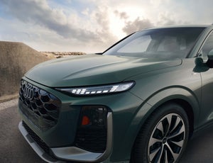 Side view of an Audi Q3 driving.